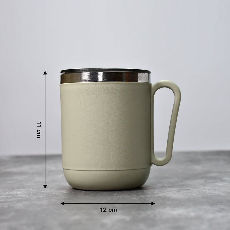 An Indian man enjoying a hot beverage from the Ganesh stainless steel coffee mug.