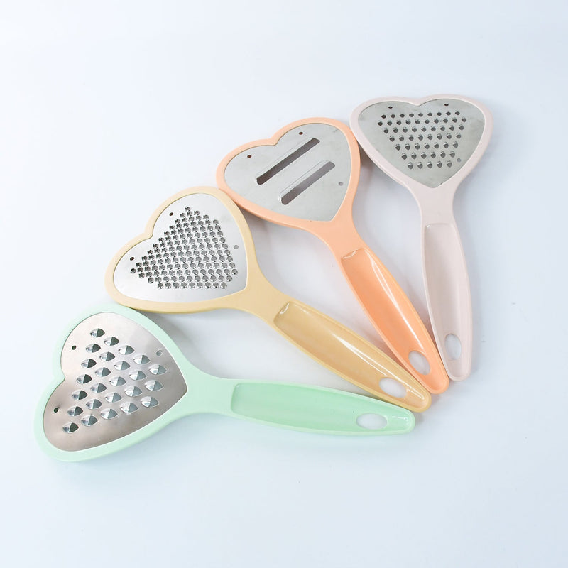 The complete set of heart grater and slicer tools displayed in a modern kitchen setting.