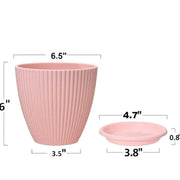 Multiple black plastic flower pots displayed from various angles to show the full set.