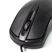 Underside view of the wired optical mouse, revealing the precise optical sensor.