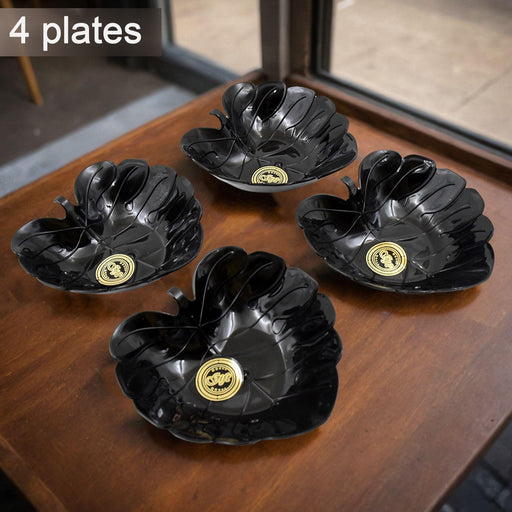 Four ceramic tea cups and four plastic leaf-shaped bowls displayed together.