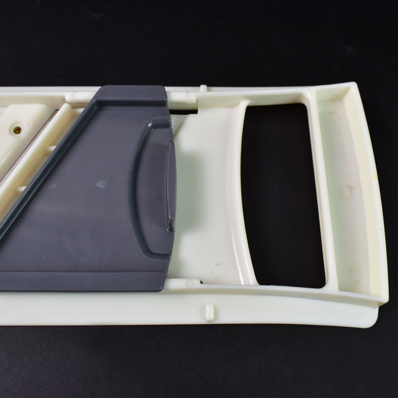 Sharp stainless steel blade of the slicer, ready for effortless vegetable slicing.