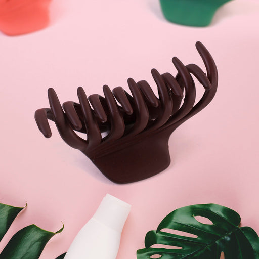 Close-up of matte plastic hair clamp on white background