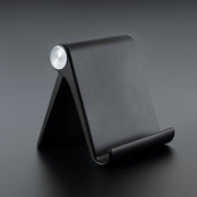 Foldable mobile stand showing adjustable angle on a study table