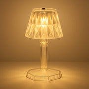 A detailed view of the acrylic crystal table lamp on a wooden surface.