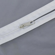 Closeup of full-length zipper on suit cover with breathable fabric.