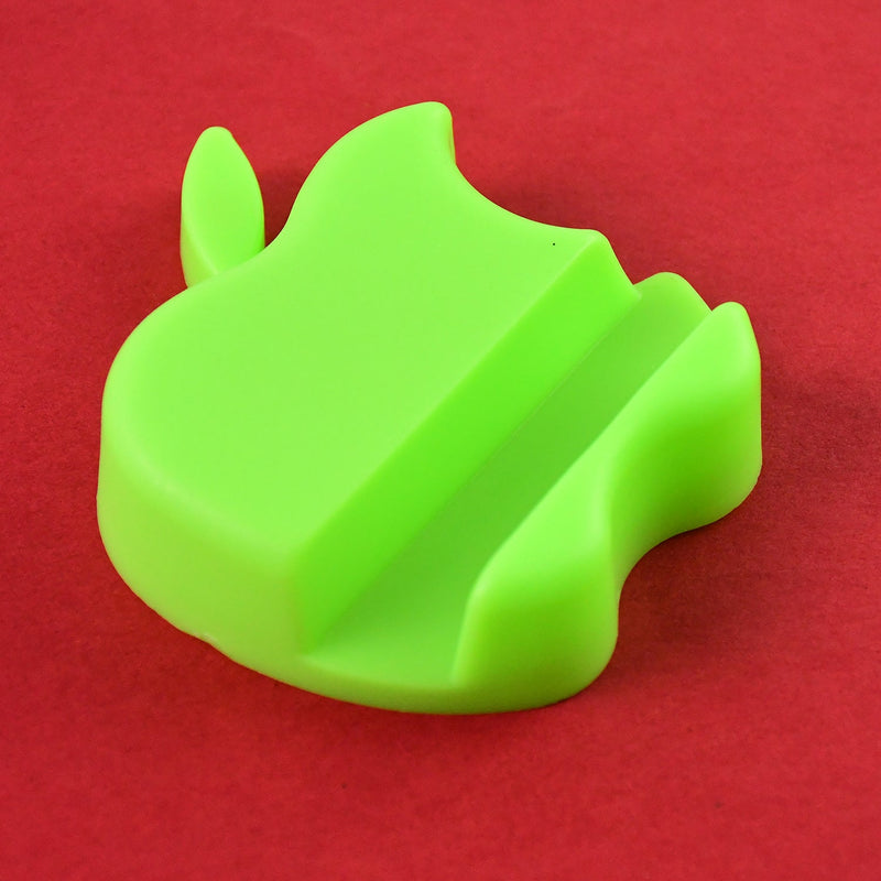 Multiple apple-shaped mobile phone stands arranged on a desk