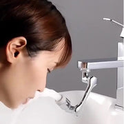 Rotating faucet sprayer installed on a modern kitchen sink tap.