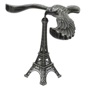 A hand demonstrating the Balancing Eagle Toy's stability by placing it on a fingertip, separate from its stand.