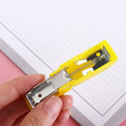 Closeup of compact colorful stapler with included staples