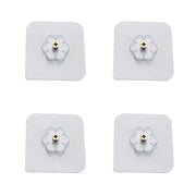 Transparent self adhesive hooks seamlessly blending into a tiled wall.