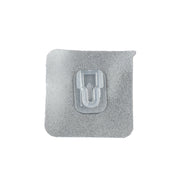 GlimmerHome transparent adhesive hook discreetly blending into a white wall.
