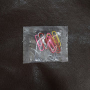 Colourful vinyl-coated paper clips securely holding important files and documents together.