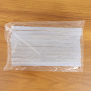Hot glue sticking wood, fabric, and paper for craft projects