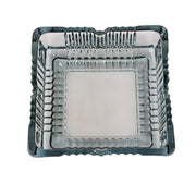 The elegant square glass ashtray displayed in a home or office setting.