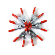Detail of the 2-inch metal spring clamp's rotating jaw pads providing a tight, secure grip.