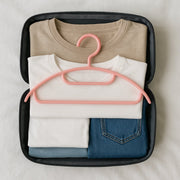 Close view of non-slip plastic hangers protecting delicate fabrics in closet