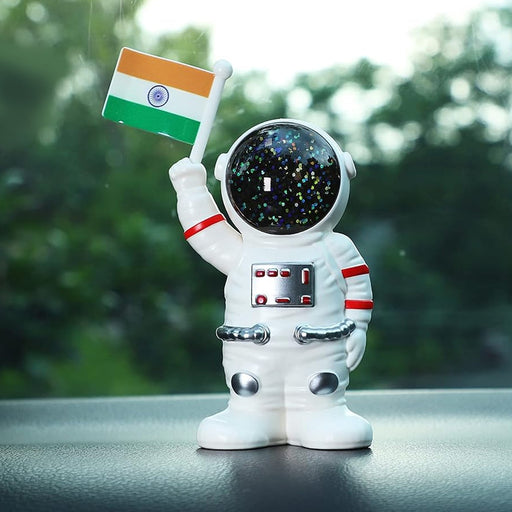 Solar powered astronaut ornament with Indian flag waving hand on car dashboard