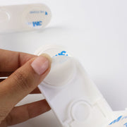 Installed baby safety corner lock on furniture for childproofing