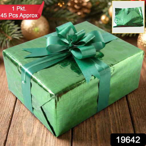 Close-up of shiny metallic gift wrapping paper featuring star pattern