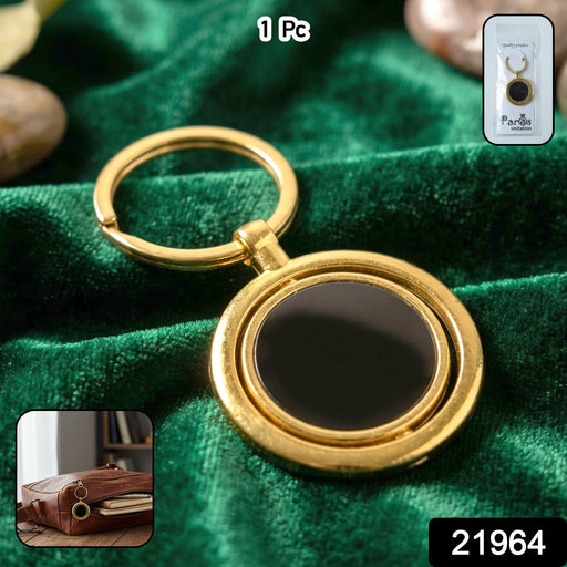 Luxury gold keychain featuring rotating black pendant, perfect for keys and bags.