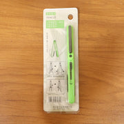 Pen-style compact scissors from FERVENT with the convenient clip attached.
