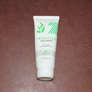 Zequz face wash tube with natural Neem and Tulsi leaves background