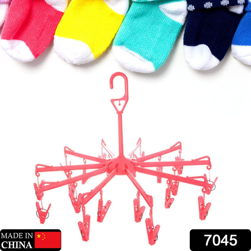 Compact plastic clothes hanger with clips in a folded position, showing portability.
