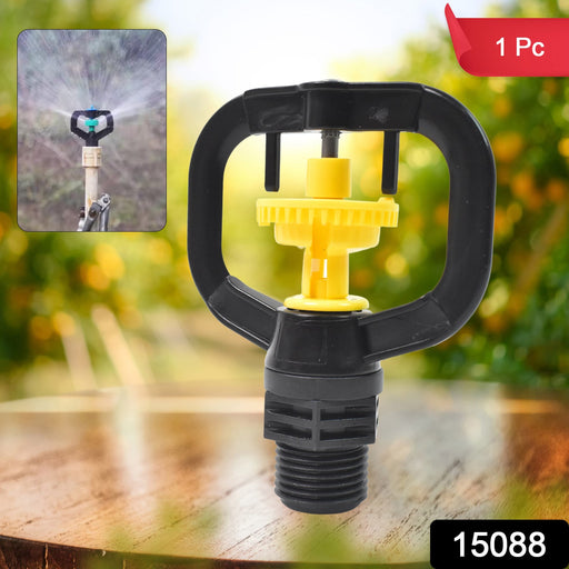 Rotating sprinkler nozzle effectively watering a lush green garden.