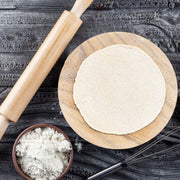 Chef pressing dough in the Round Roti Maker to create a perfect chapati.