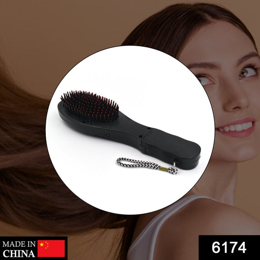 Ergonomic electric hair massager comb showing its vibrating function.