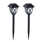 FitFuzion solar pathway lights casting bright, artistic patterns on a dark garden path, enhancing outdoor decor.