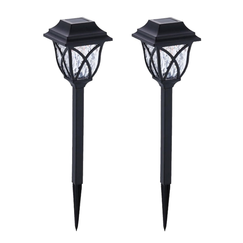 FitFuzion solar pathway lights casting bright, artistic patterns on a dark garden path, enhancing outdoor decor.