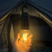 Outdoor campsite illuminated by solar camping lantern