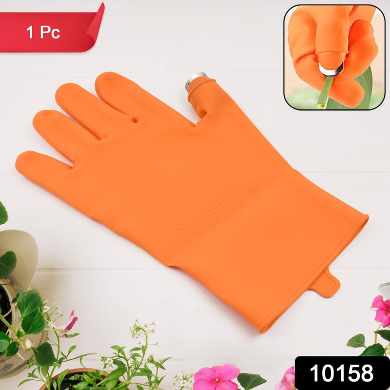 Right-Handed Thumb Cutter Glove being used to harvest a red chilli pepper from a plant.