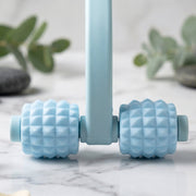 Close-up of textured balls on the handheld muscle roller.