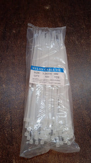 A pile of black nylon cable ties, showcasing their quantity and readiness for use.