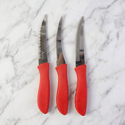 Kitchen knife slicing a tomato