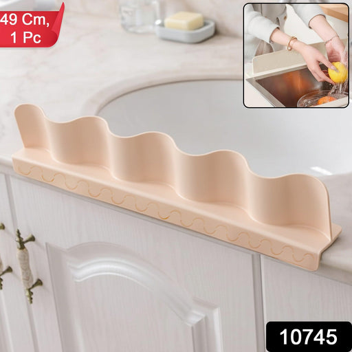 Anti-splash kitchen sink guard protecting countertop from water spill