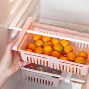 A single fridge organizer drawer filled with snacks and small items.