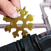 Close-up of the durable stainless steel Snowflake Multi-Tool, highlighting its intricate design.