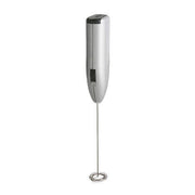 Close-up of the electric milk frother creating creamy foam in a mug.