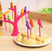 Set of colorful bird fruit forks with a tree holder, perfect for kids' snack time.