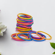 Multicolor rubber bands neatly arranged in a stack on a white surface.