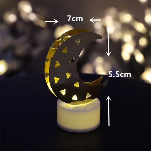 Decorative crescent moon shaped flameless LED candle emitting warm yellow glow