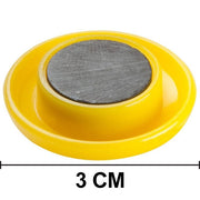 Kids' magnetic buttons securely sticking to a metal surface.