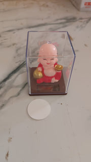 Solar Buddha Car Ornament in natural light, demonstrating its automatic head movement.