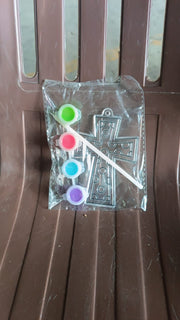 Assorted acrylic paint tubes and a plastic stencil for creative projects.
