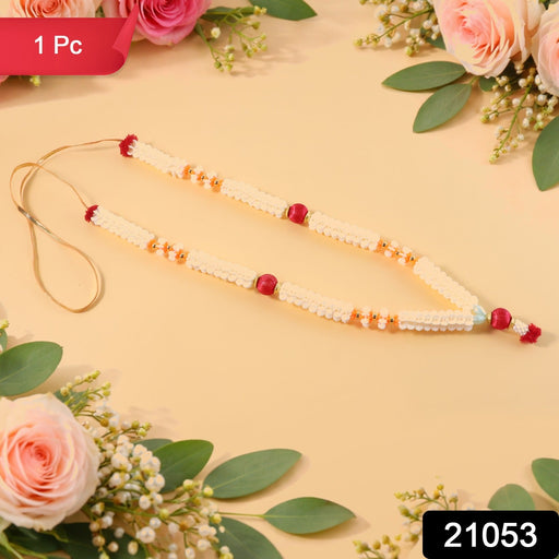 Close-up of decorative pooja flower gajra garland with bead accents