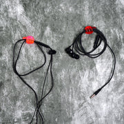 A set of multi-functional hand shape wall clips holding various items like cables and keys.